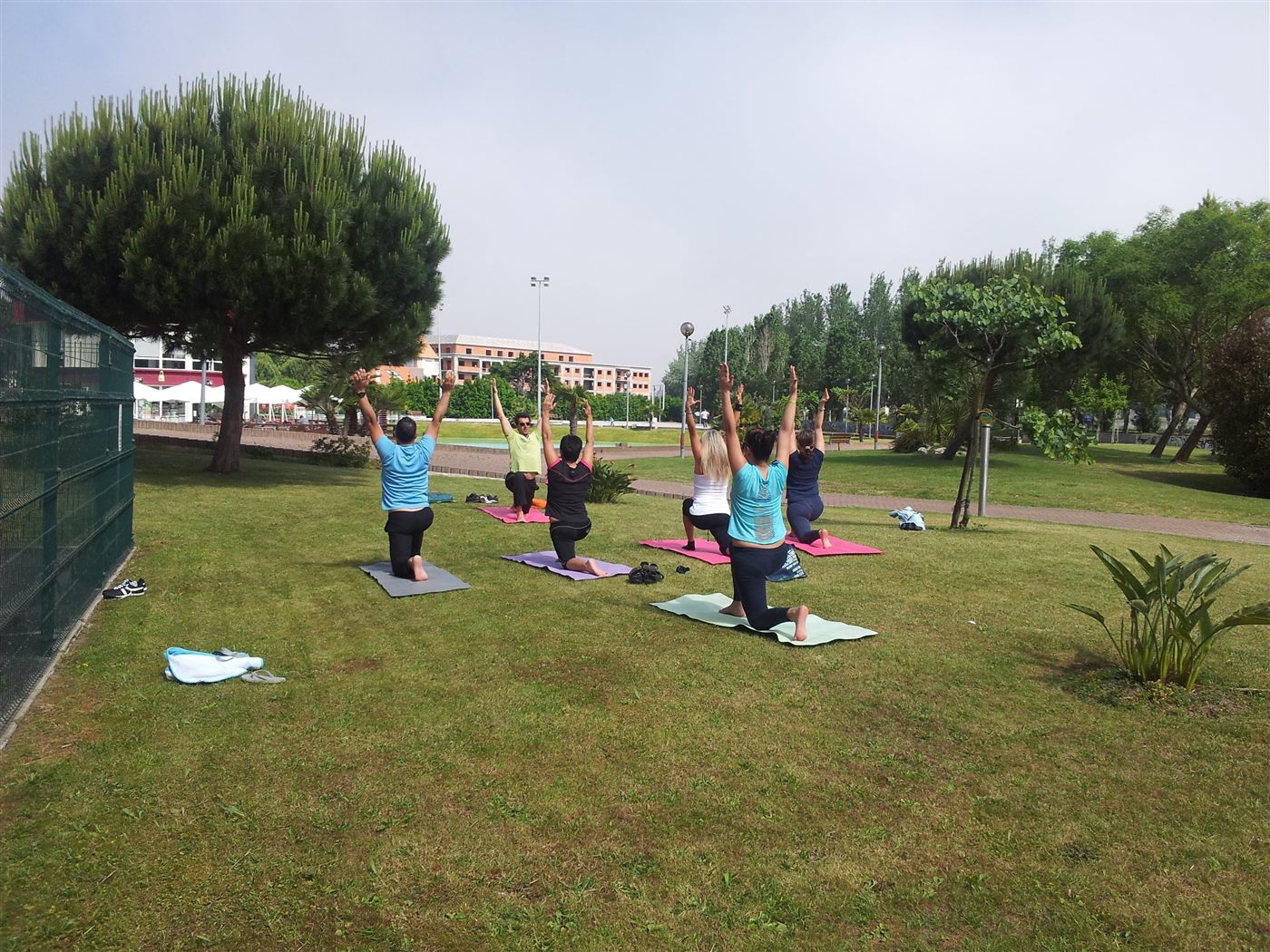 Carlos teaching an outdoor yoga class on the grass